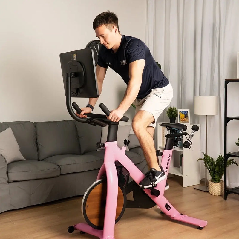 a man rides freebeat pink exercise bike 